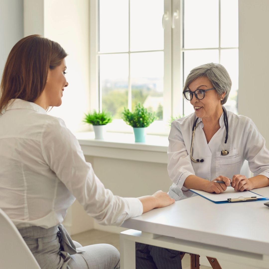 Senior female doctor talking with a patient.