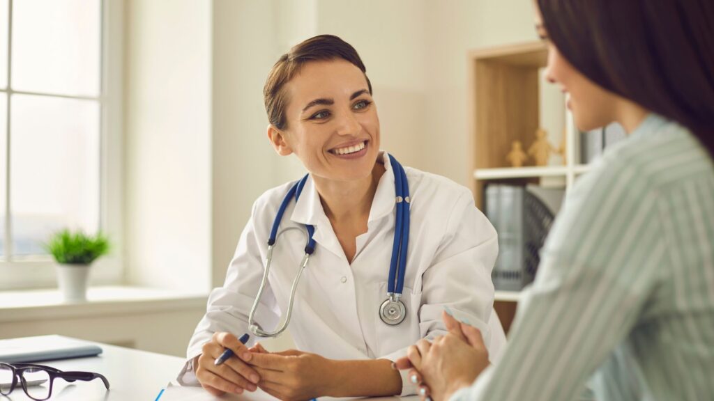 Cheerful female doctor consulting with a patient.
