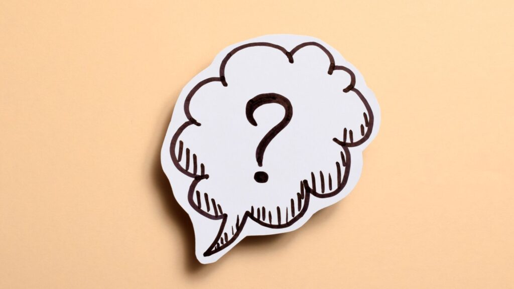 Speech bubble with question mark on beige background.