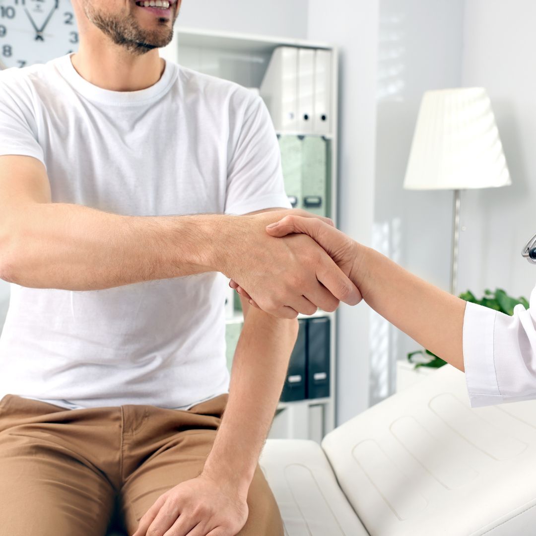Patient shaking hands with a doctor.