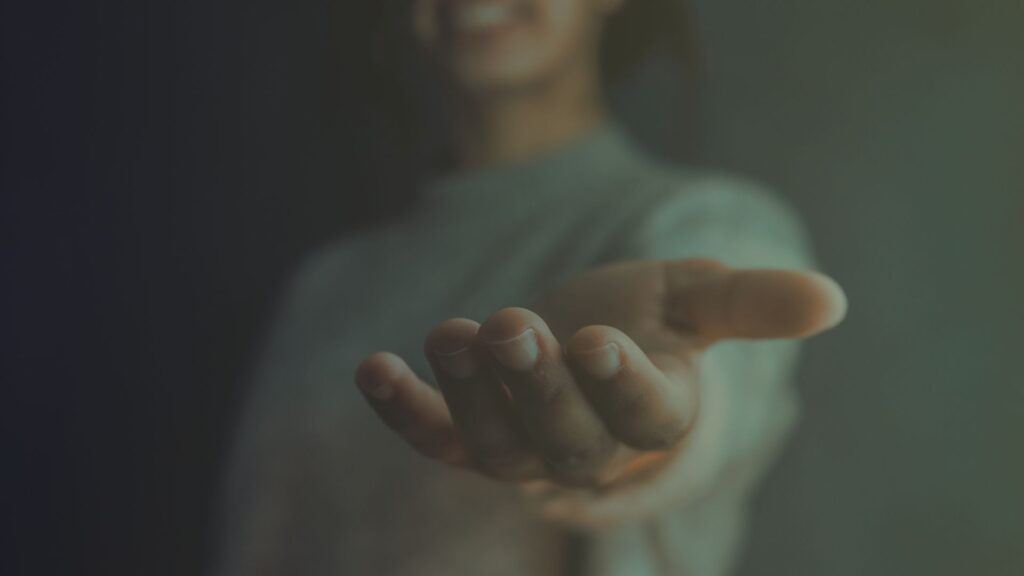 Person offering an outstretched, open hand.