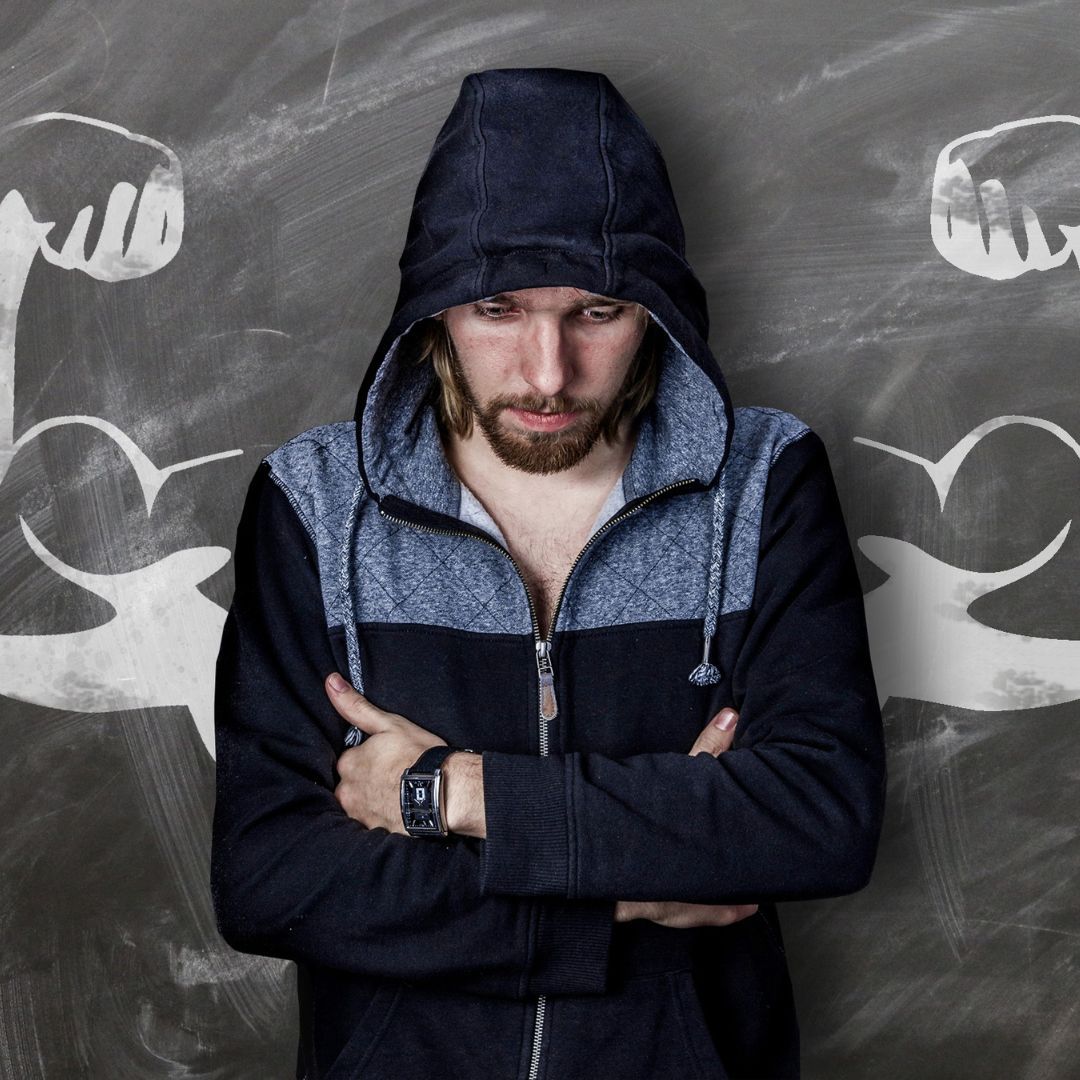 Discouraged man standing in front of drawn muscles.