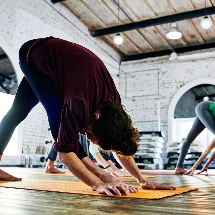 People practicing yoga stretches in a studio class.