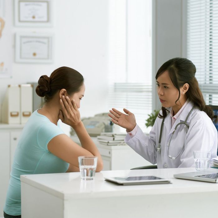 Female doctor consulting with a patient in an office.